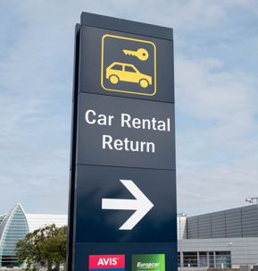 Sign showing the way to the car rental return stock photo